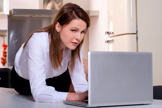 woman in the kitchen with laptop