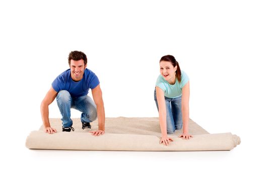 couple unrolling a carpet