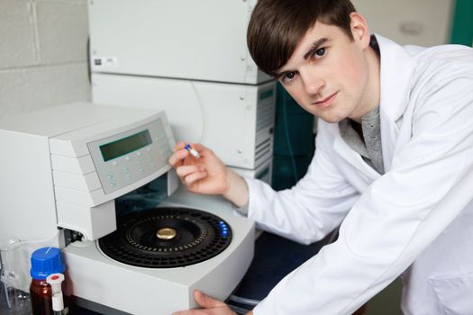 Chemist using a centrifuge