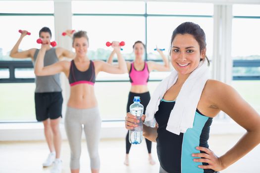 Woman at front of aerobics class 
