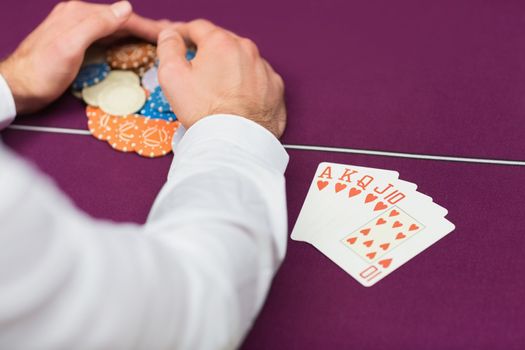 Man winning at poker with royal flush