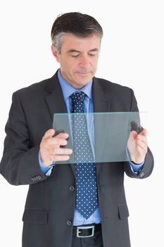 Businessman looking at clear pane