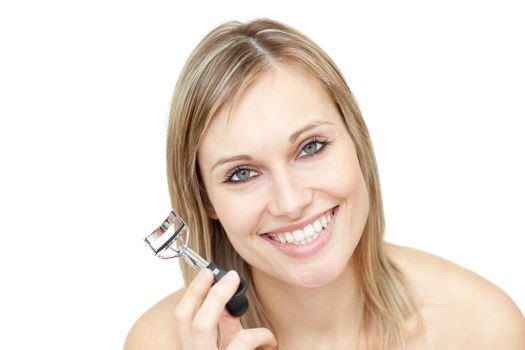 Cheerful woman holding an eyelash curler 
