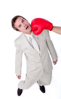Caucasian businessman being hit with a boxing glove 