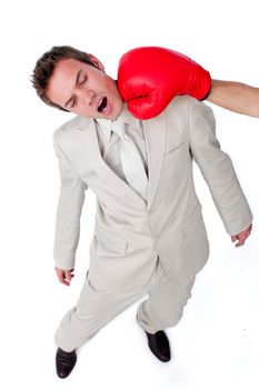 Young businessman being hit with a boxing glove