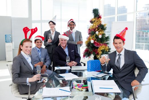 Portrait of a smiling business team wearing novelty Christmas ha