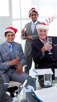 Confident businessmen wearing novelty Christmas hat