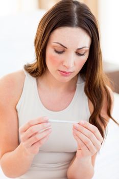 Pensive woman finding out results of a pregancy test