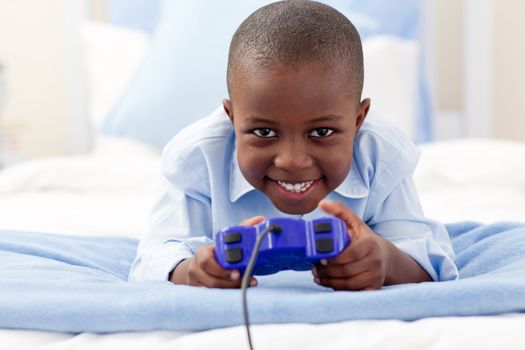 Smiling little boy playing video game