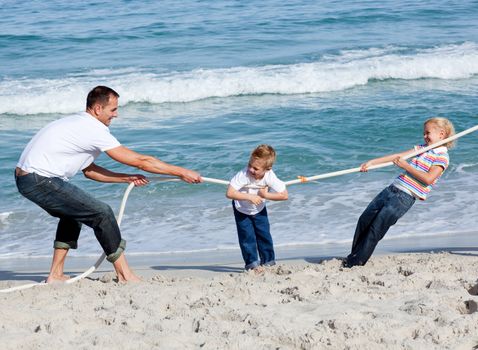 Happy family playing tug of war