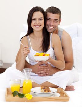 Couple having nutritive breakfast in bed
