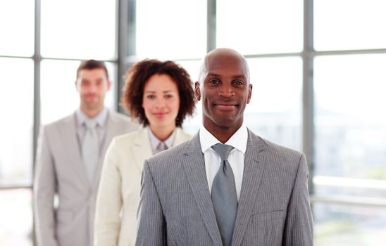 Smiling African-American businessman leading his colleagues