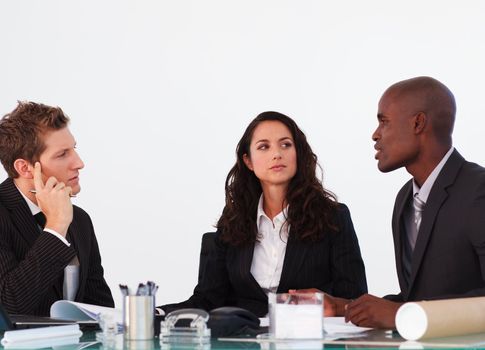 Three business people interacting in a meeting