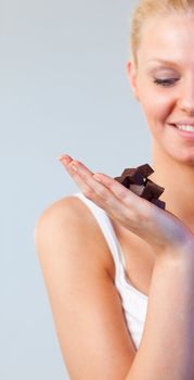 Attractive woman looking at chocolate focus on chocolate 