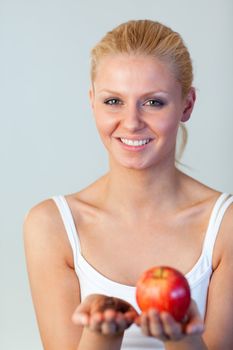 Beautiful woman holding chocolate and apple focus on woman 