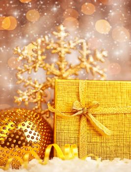 Golden Christmas gift with baubles decorations