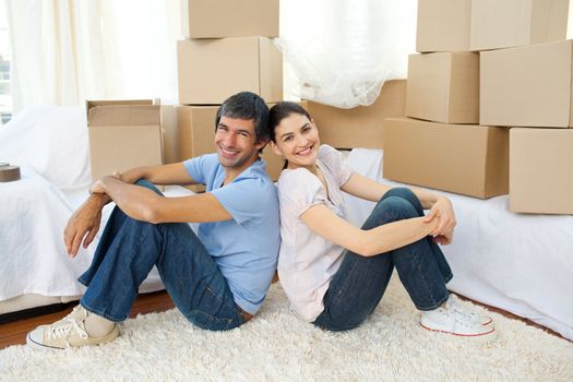 Happy couple relaxing while moving house