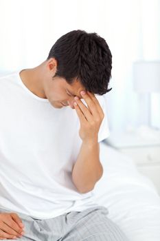 Attractive man having a headache and touching his forehead 