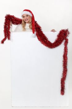 Christmassy woman with a board left blank for your message