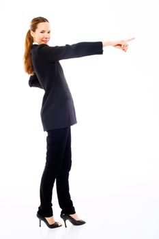 Young businesswoman standing with her hand indicating on white b
