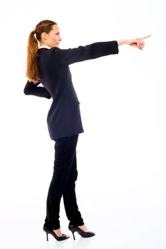 Young businesswoman standing with her hand indicating on white b