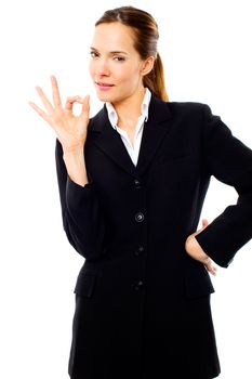 young businesswoman with her hand indicating ok on white backgro