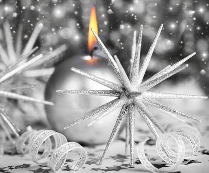 Silver holiday background with candle and Christmas tree ornament and decoration