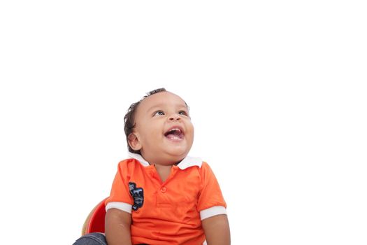 Baby laughing over white background. Active one year child 