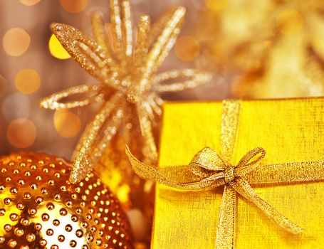 Golden Christmas gift with baubles decorations