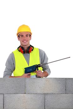 Man using drill with long bit