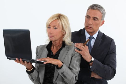 Mature business couple with a laptop