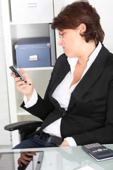 Businesswoman pulling a face at a text message Business woman making a face