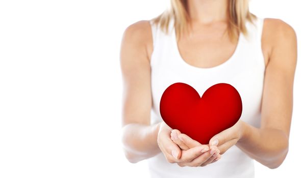 Healthy woman holding heart, selective focus