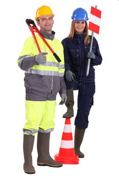Manual workers stood with traffic cones