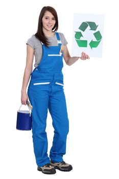 Female painter holding recycle logo