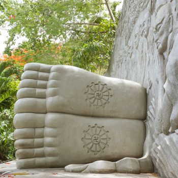 Feet of a sleeping buddha, decorated with a swastika