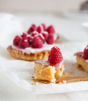 Raspberry frangipane tarts with icing drizzled over the top