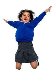 Jubilant school kid jumping high up in the air