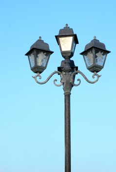 old street light against blue sky