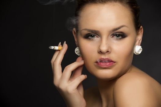 Stylish woman smoking a cigarette