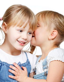 Little girls sharing a secret