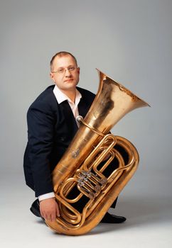 Portrait  of a young tubaist with his instrument