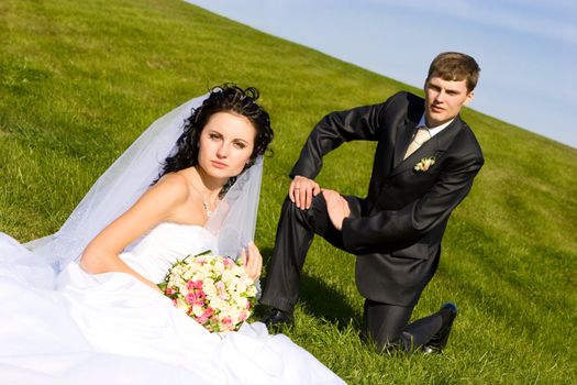 bride and groom on the grass