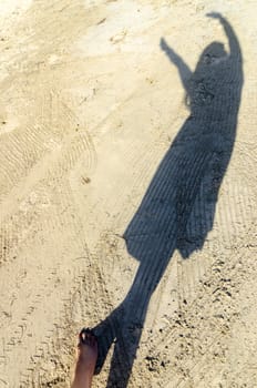 Shadow of a woman on a white sand beach in San Andres y Providencia, Colombia