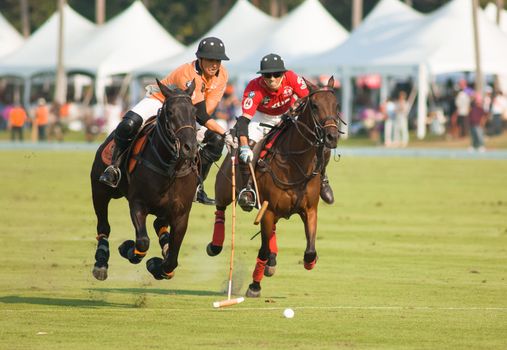 PATTAYA - JANUARY 19: Players fighting for the ball during the final between Thai Polo and Axus Polo at Thai Polo Open on January 19, 2013 in Pattaya, Thailand.