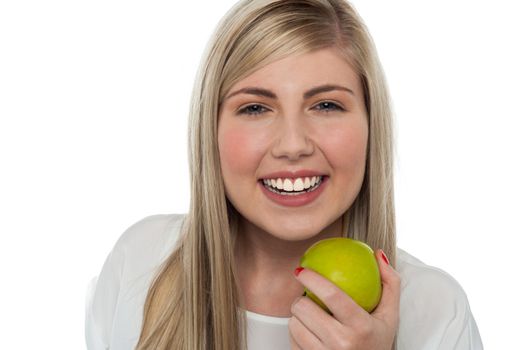 Health conscious girl holding green apple
