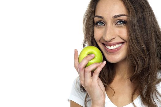 Health conscious woman about to eat fresh green apple