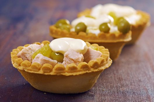 tartlet with salad on wooden board