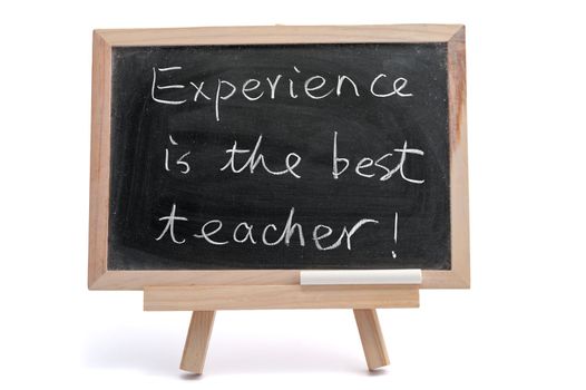 "Experience is the best teacher" saying written on blackboard over white background