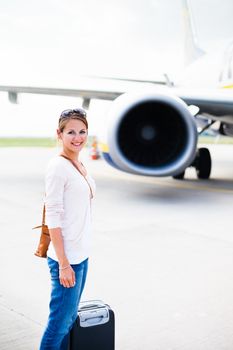 young woman at an airport having just left the aircraft